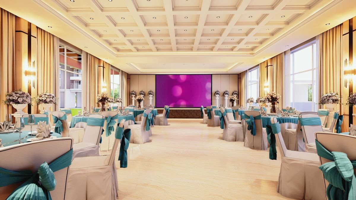 Multipurpose hall laid out with round tables for a function, with a coffered ceiling