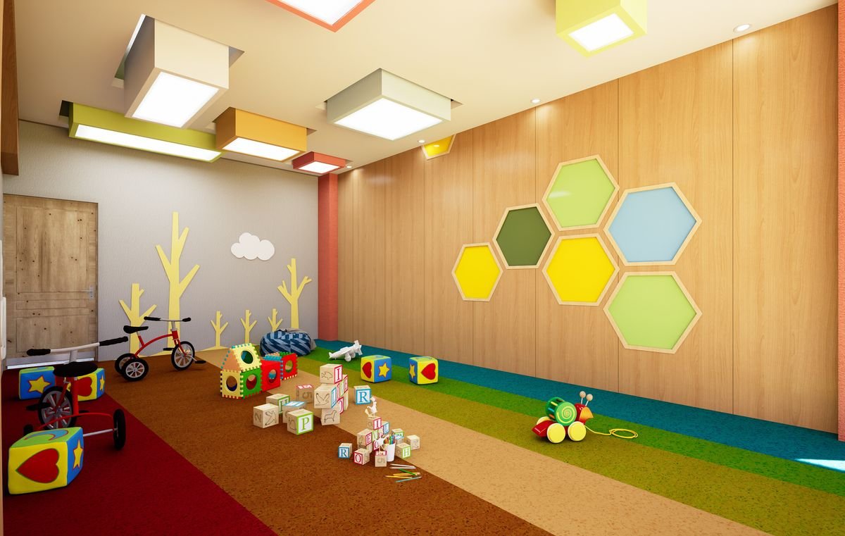 Children's indoor play room with soft coloured flooring and hexagonal wall panels