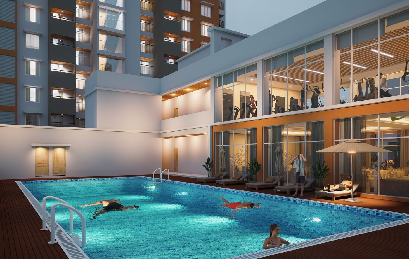 Swimming pool at dusk with the glazed gymnasium alongside it